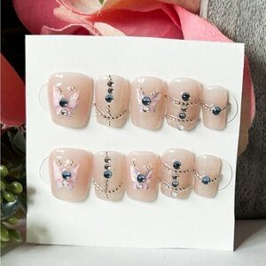 Elegant Nude Press-On Nails with Black Accents
Medium size